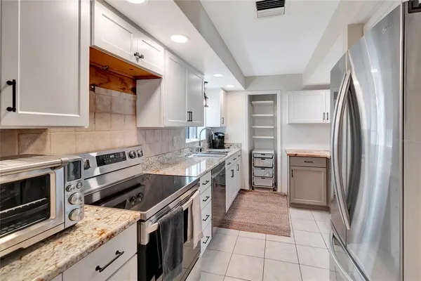 a kitchen with a sink stove and refrigerator