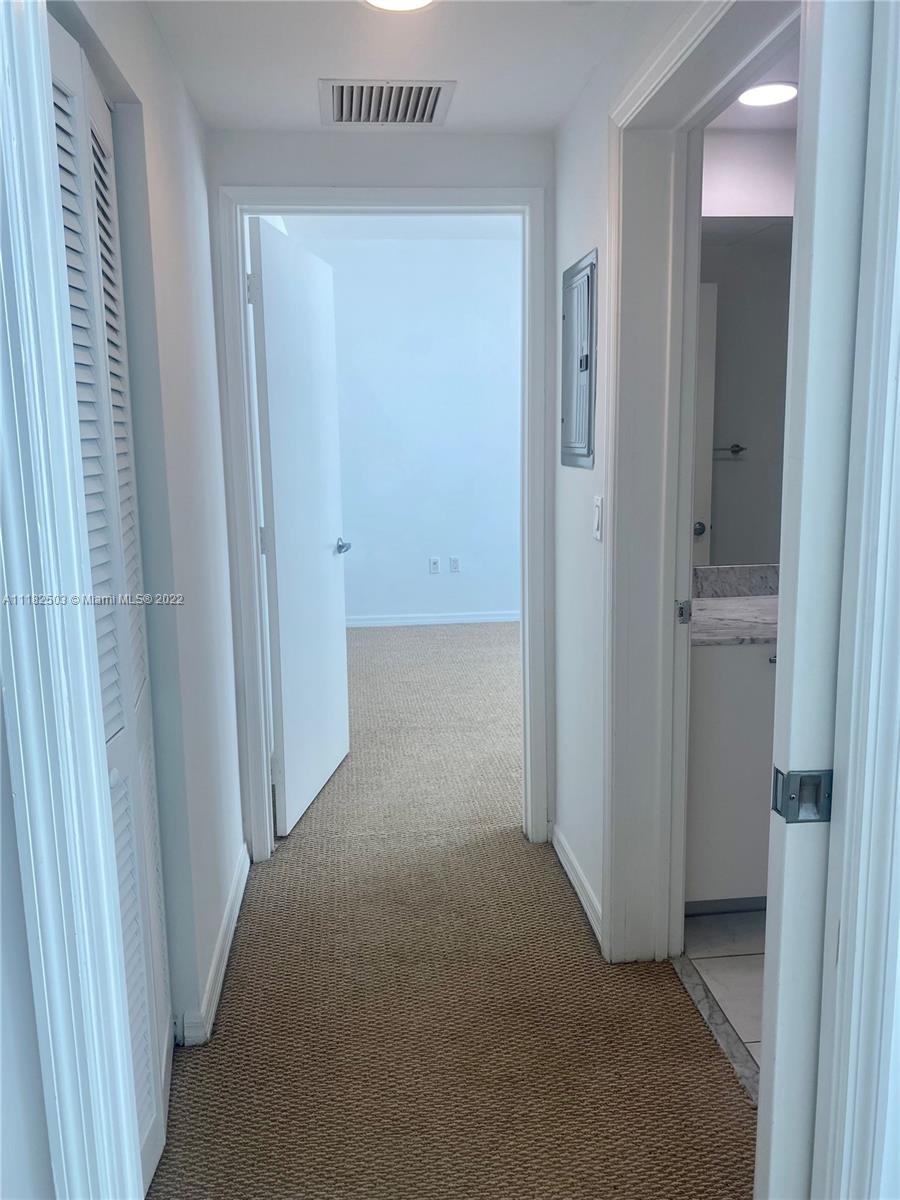 950 Brickell Bay Drive, Unit 602 Miami, FL 33131 - Photo 12 of 16 a view of a hallway to rooms