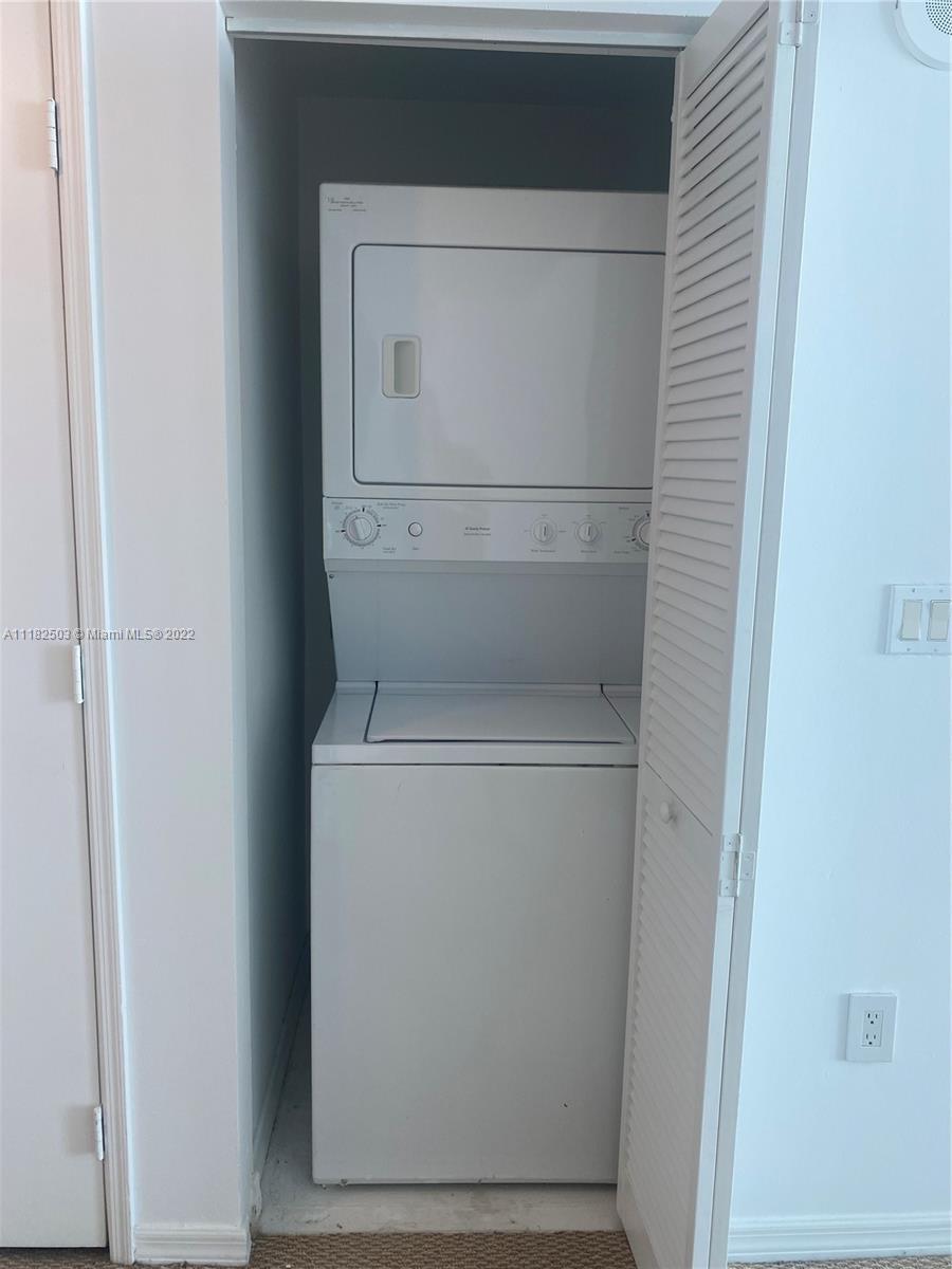 950 Brickell Bay Drive, Unit 602 Miami, FL 33131 - Photo 16 of 16 a utility room with dryer and washer