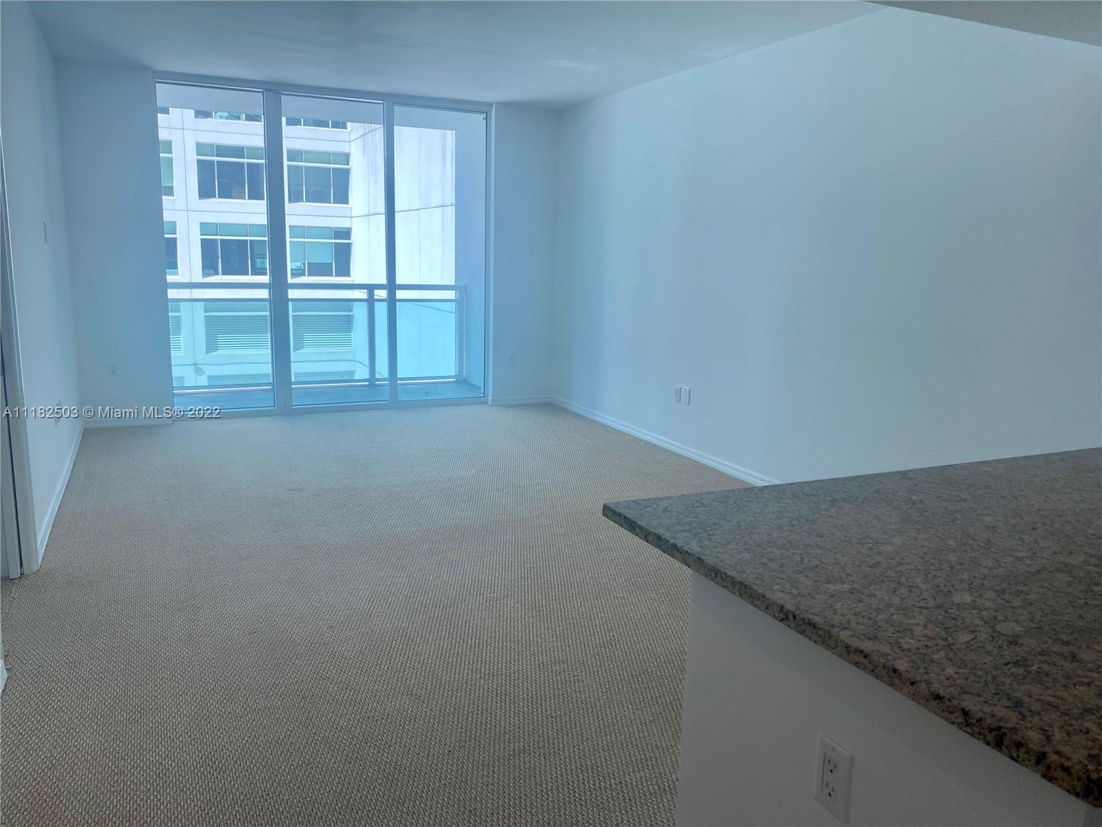 950 Brickell Bay Drive, Unit 602 Miami, FL 33131 - Photo 6 of 16 an empty room with a empty space and windows
