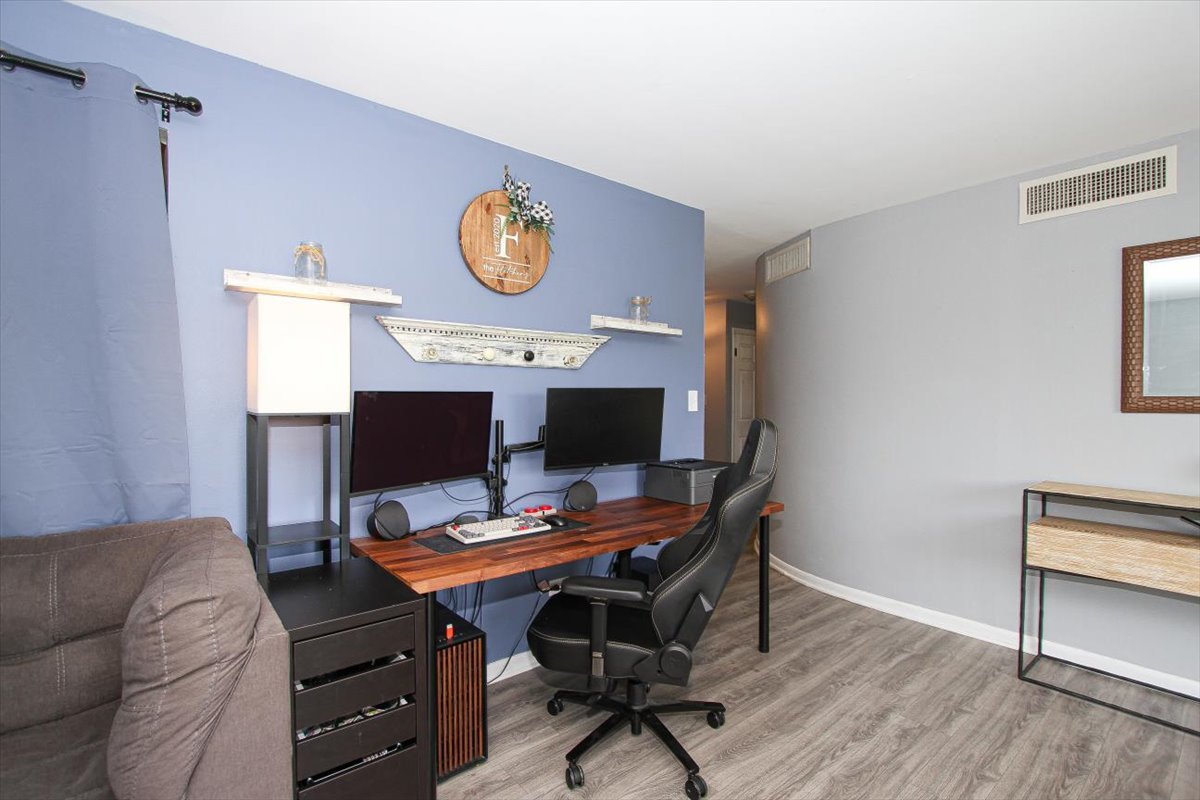 2300 Old Tavern Road, Unit 203 Lisle, IL 60532 - Photo 9 of 26 a workspace with furniture and wooden floor