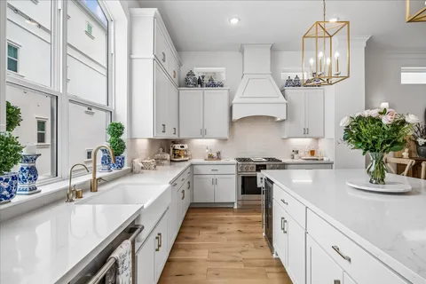 a kitchen with kitchen island granite countertop a sink stainless steel appliances and cabinets