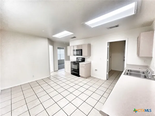 a kitchen with a sink and cabinets
