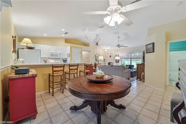 a room with stainless steel appliances kitchen island granite countertop furniture and a kitchen view