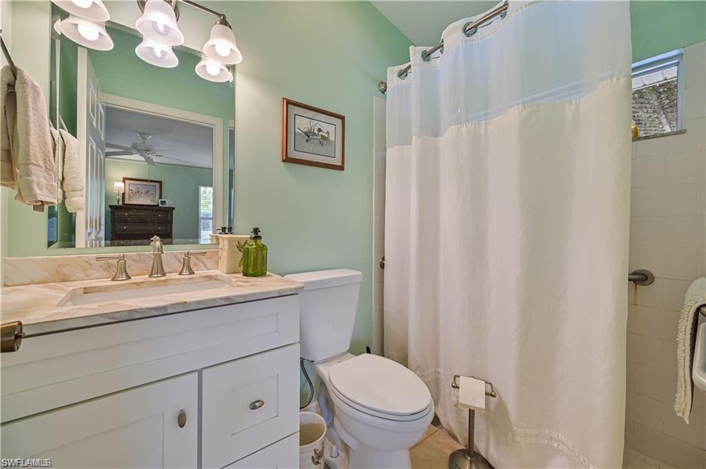 18546 Violet Road Fort Myers, FL 33967 - Photo 21 of 38 a bathroom with a granite countertop toilet sink and mirror