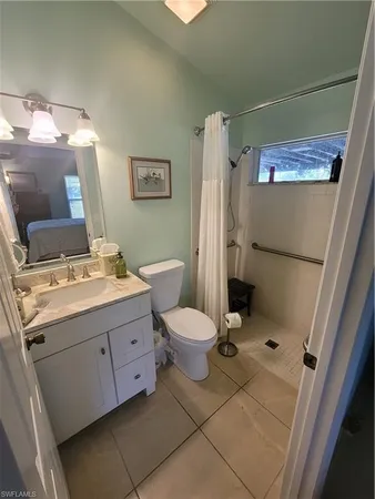 a bathroom with a granite countertop toilet sink and a mirror