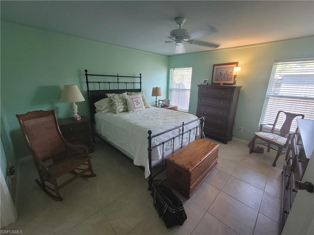 18546 Violet Road Fort Myers, FL 33967 - Photo 23 of 38 a bedroom with a bed chair and piano