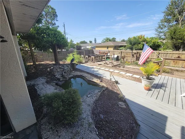 a backyard of a house with table and chairs