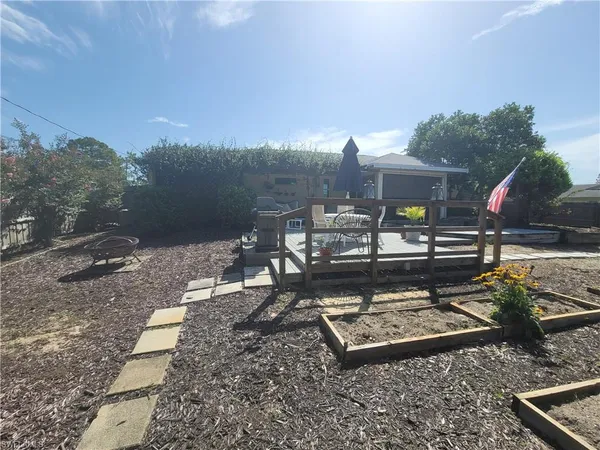a view of a backyard with sitting area