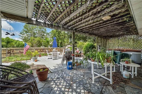 a view of a chair and tables in patio