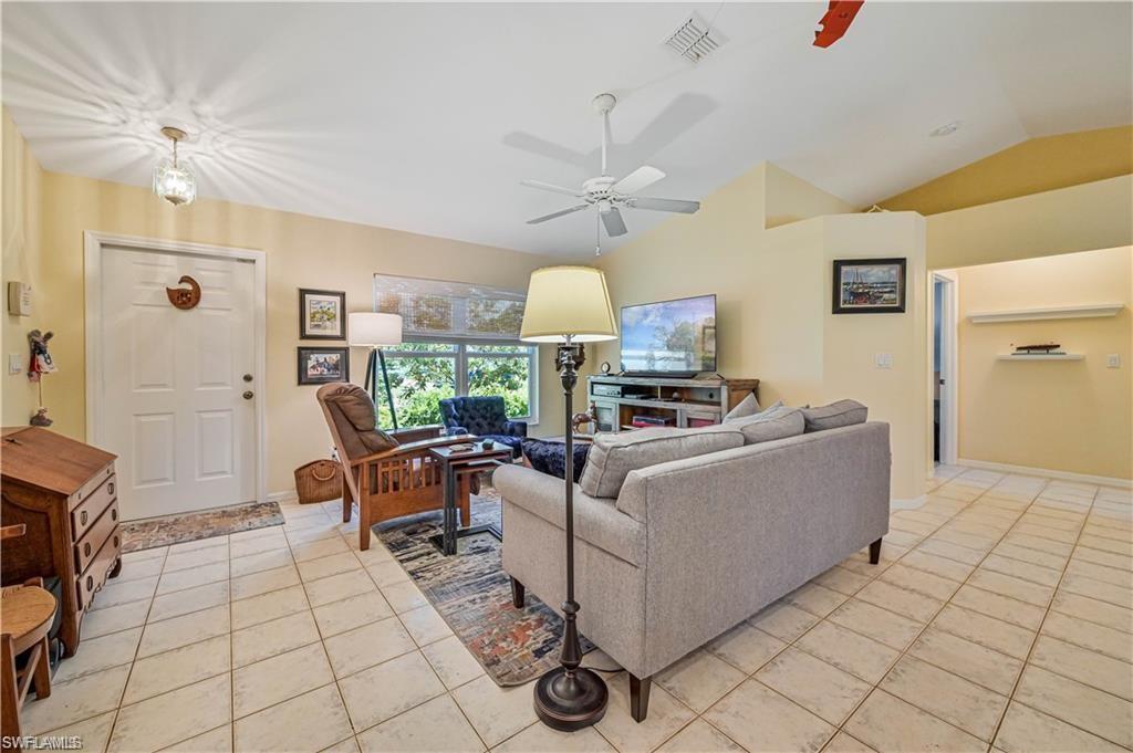 18546 Violet Road Fort Myers, FL 33967 - Photo 7 of 38 a living room with furniture and a chandelier