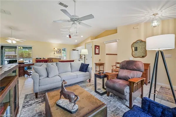 a living room with furniture a rug and a chandelier