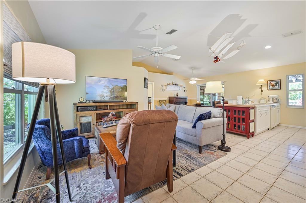 18546 Violet Road Fort Myers, FL 33967 - Photo 10 of 38 a living room with furniture a flat screen tv and a rug