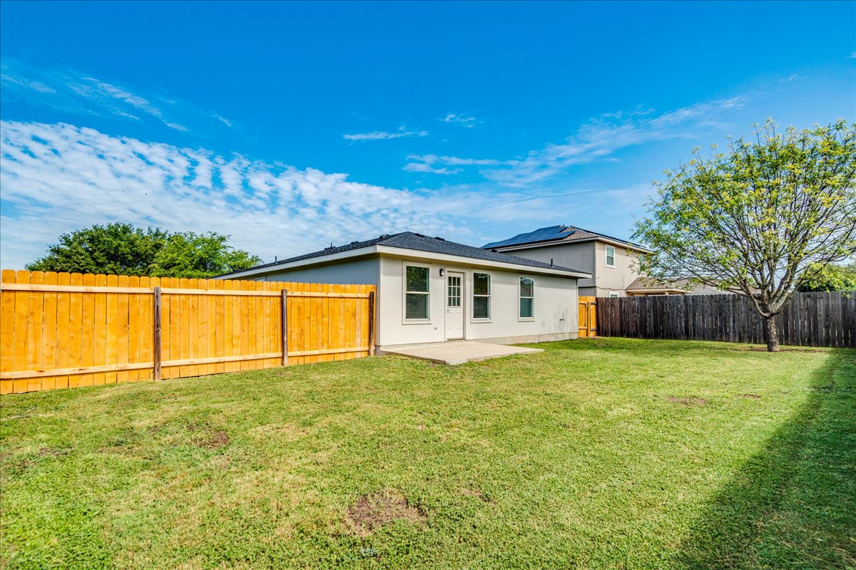 100 Easy Street Hutto, TX 78634 - Photo 29 of 36 A spacious, enclosed backyard offers abundant room for recreation and relaxation under the open sky.