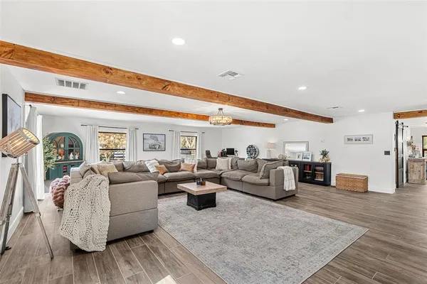 a living room with furniture and wooden floor
