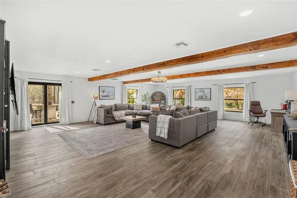 a living room with furniture and wooden floor