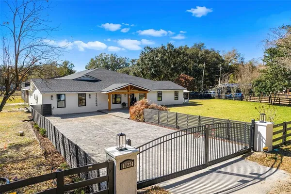 a view of a house with swimming pool and sitting area
