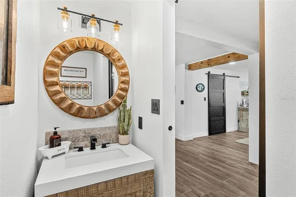 a bathroom with a sink a mirror and a closet