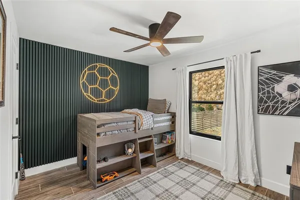 a bedroom with a bed and a window