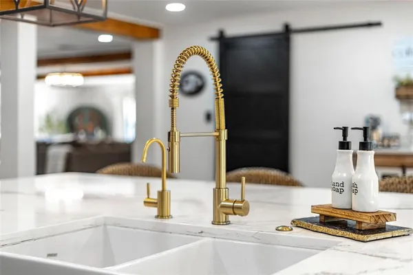 a kitchen with a sink and a mirror
