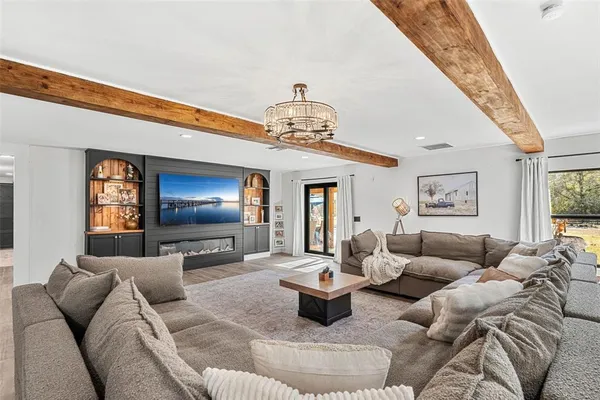 a living room with furniture and a chandelier