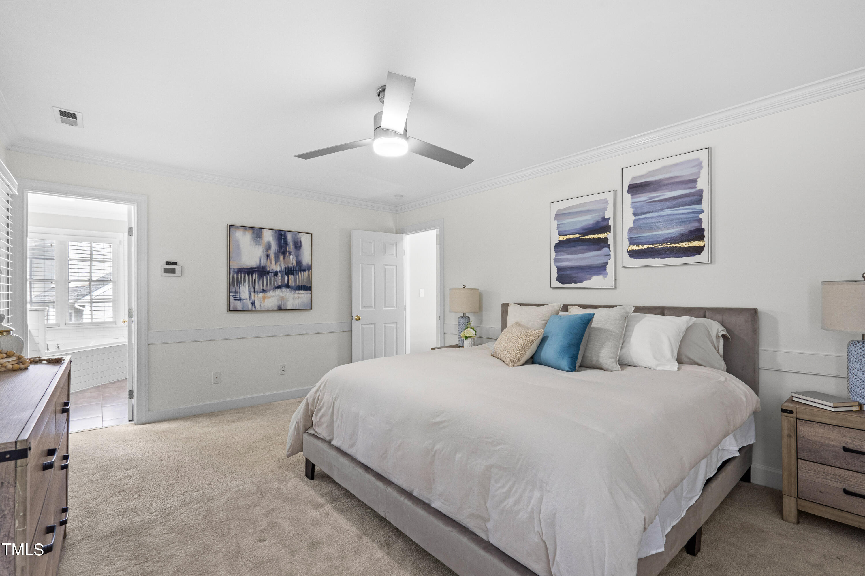 2917 Dahlgreen Road Raleigh, NC 27615 - Photo 15 of 36 a bedroom with a large bed and a chandelier