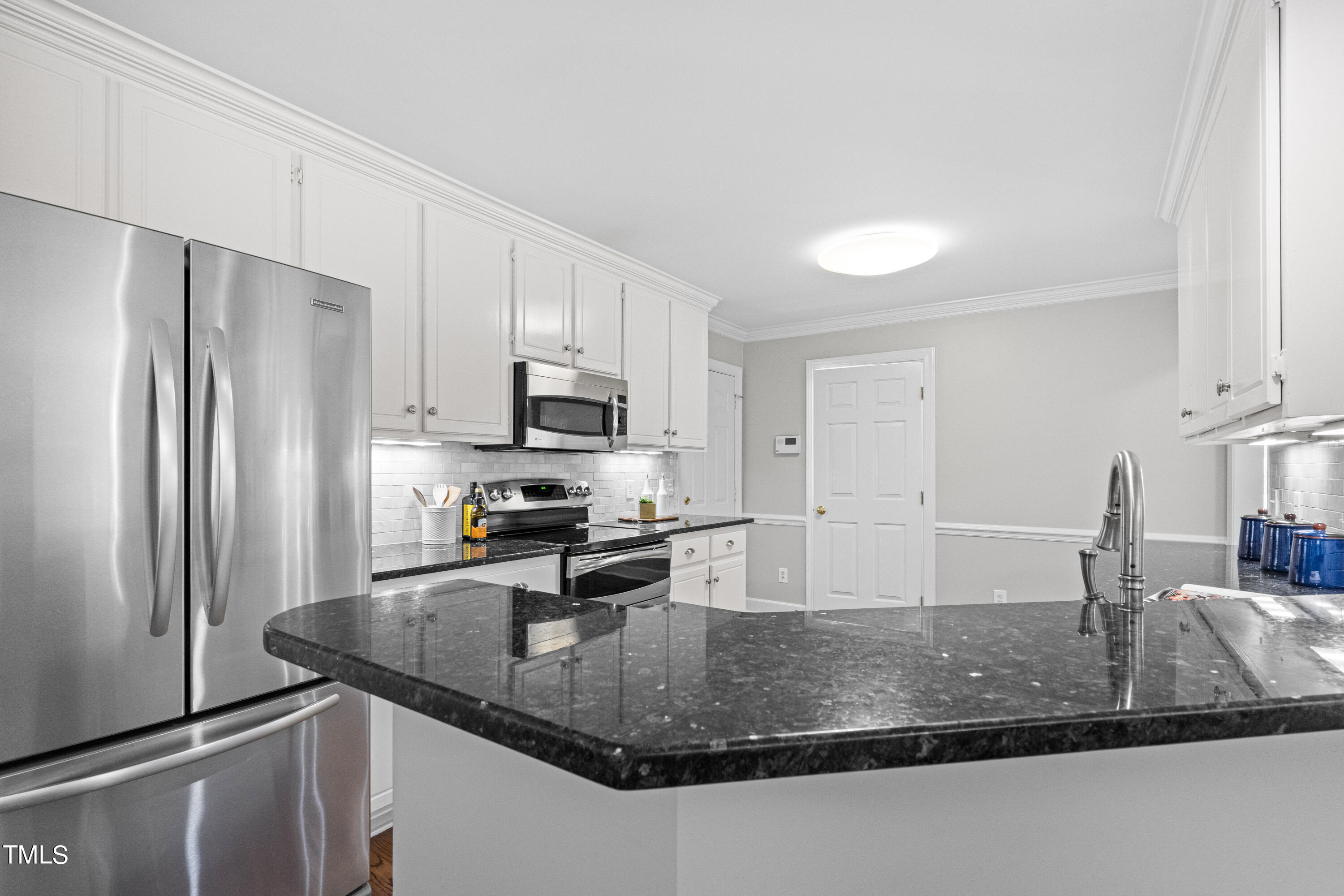 2917 Dahlgreen Road Raleigh, NC 27615 - Photo 6 of 36 a kitchen with stainless steel appliances granite countertop a sink a refrigerator and a granite counter tops