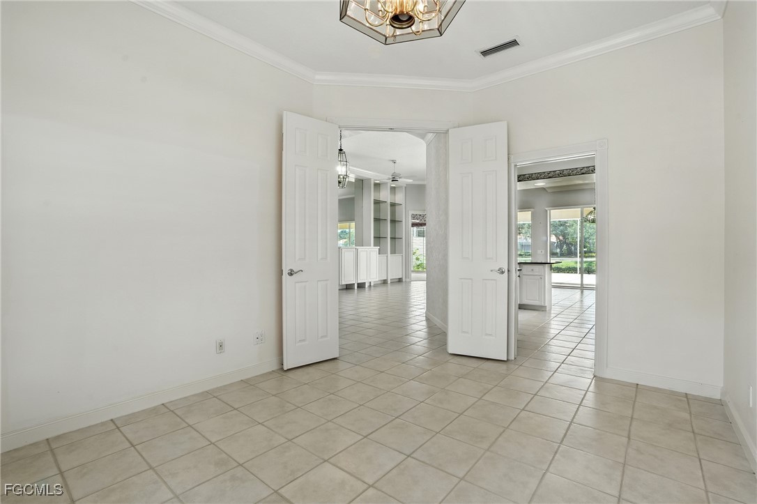 4017 Isla Ciudad Court Naples, FL 34109 - Photo 13 of 36 a view of a hallway with wooden shelves