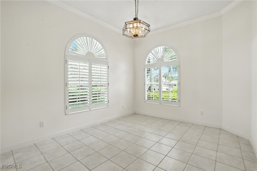 4017 Isla Ciudad Court Naples, FL 34109 - Photo 14 of 36 an empty room with windows and fan