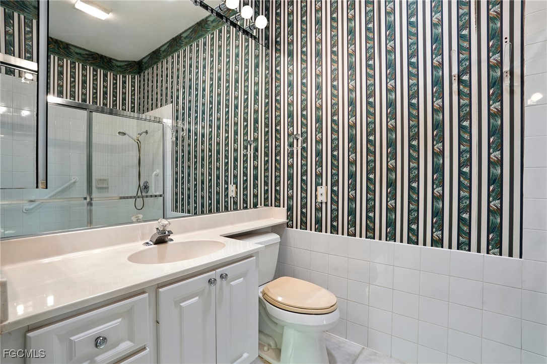 4017 Isla Ciudad Court Naples, FL 34109 - Photo 21 of 36 a bathroom with a sink toilet and shower