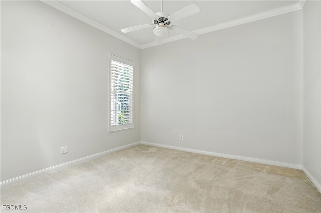4017 Isla Ciudad Court Naples, FL 34109 - Photo 22 of 36 an empty room with windows and ceiling fan
