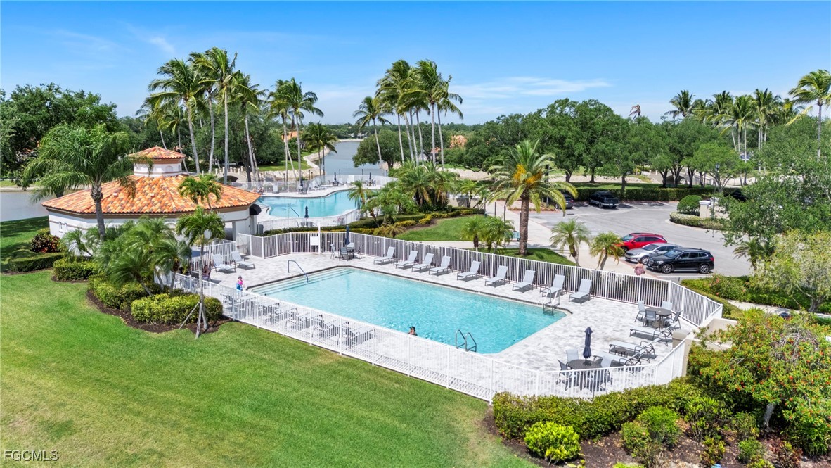 4017 Isla Ciudad Court Naples, FL 34109 - Photo 31 of 36 a view of a swimming pool with a patio and a garden