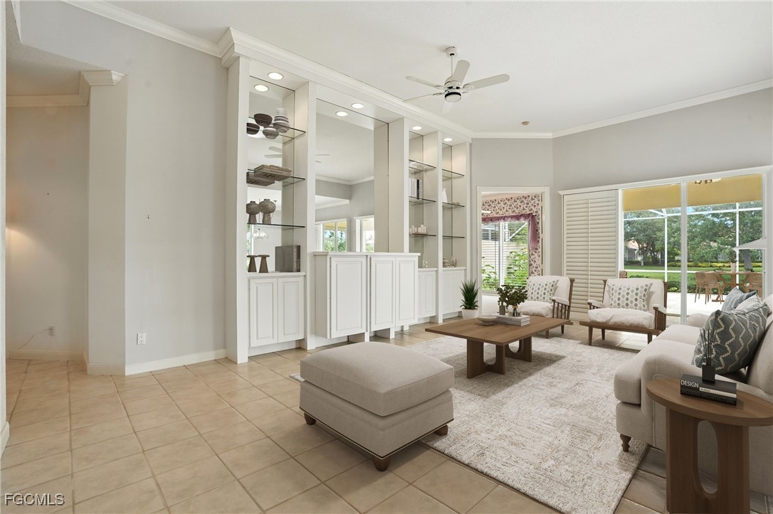 4017 Isla Ciudad Court Naples, FL 34109 - Photo 5 of 36 a living room with furniture and large windows