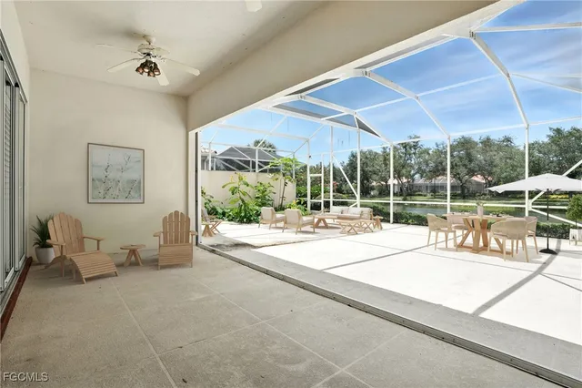 a view of a living room and floor to ceiling window and an entryway