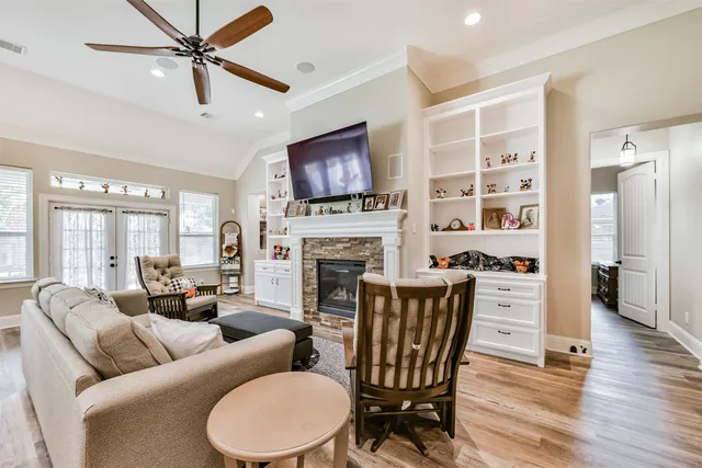 a living room with furniture and a wooden floor