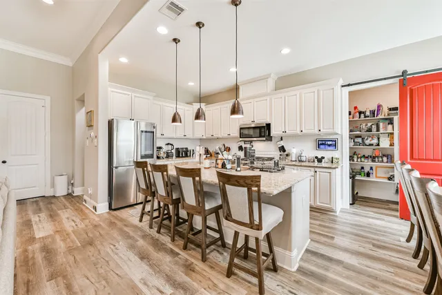 a kitchen with lots of appliances and wooden cabinets