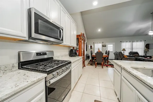a kitchen with stainless steel appliances a stove a sink and a microwave