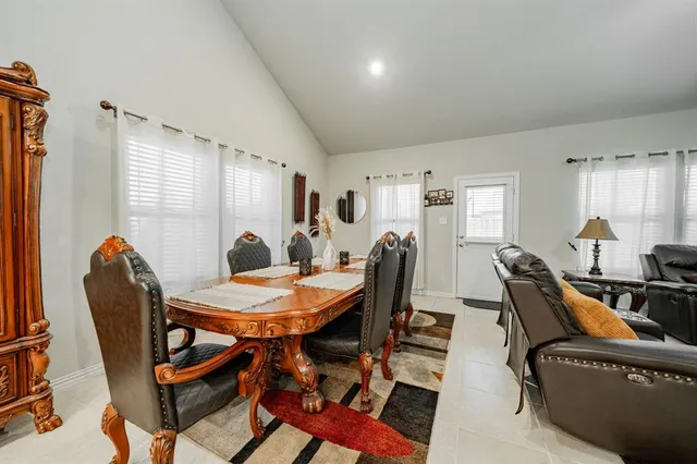 a view of a dining room with furniture and window