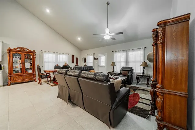 a living room with lots of furniture and a window