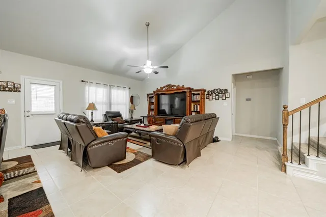a living room with furniture a chandelier and a dining table