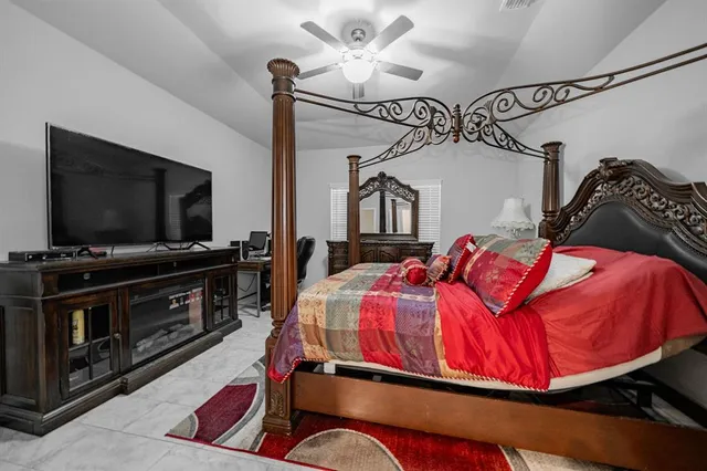 a bedroom with a bed and a flat screen tv