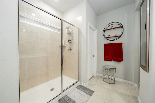 a bathroom with a shower and a mirror