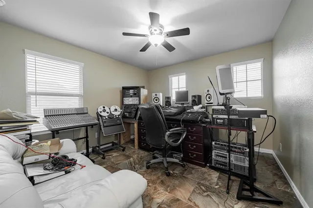 a view of a workspace with furniture and a window