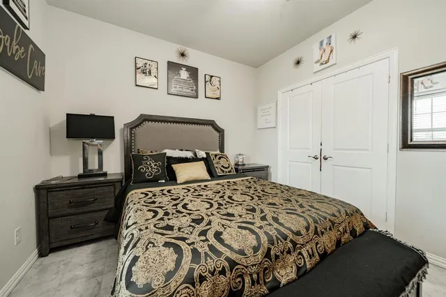 a bedroom with a bed and painting on the wall