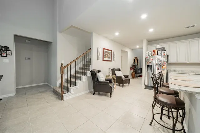 a kitchen with cabinets and chairs