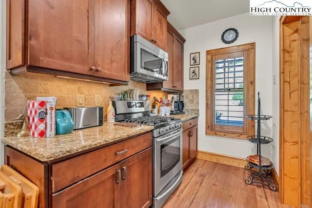 a kitchen with stainless steel appliances granite countertop a stove and a sink