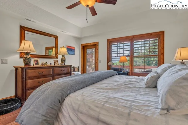 a bedroom with a large bed and a dresser