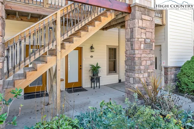 a view of front door of house with stairs