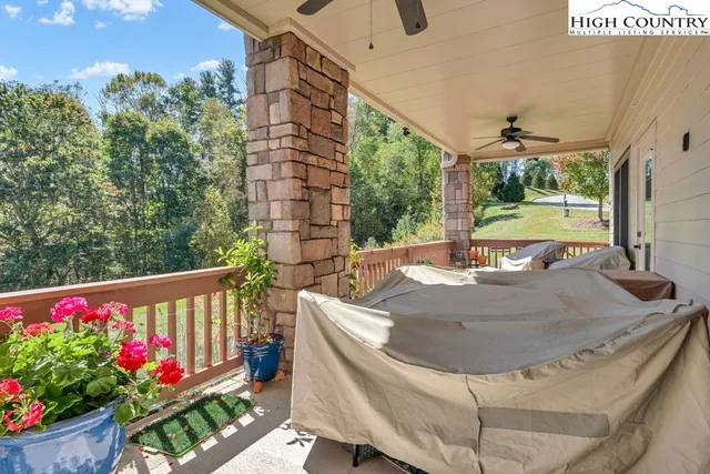 a view of a balcony with flower plants