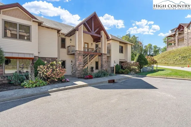 a front view of a house with a yard and a garage